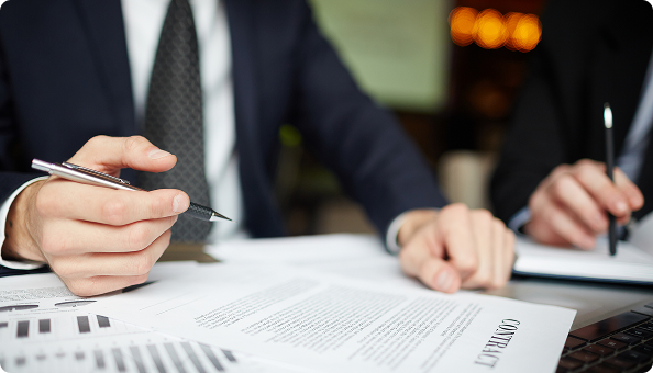 Legal professionals reviewing a contract at a desk